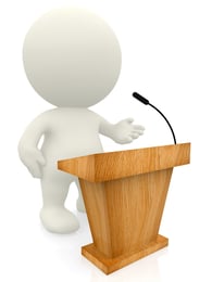 3D person standing by a lectern isolated over a white background